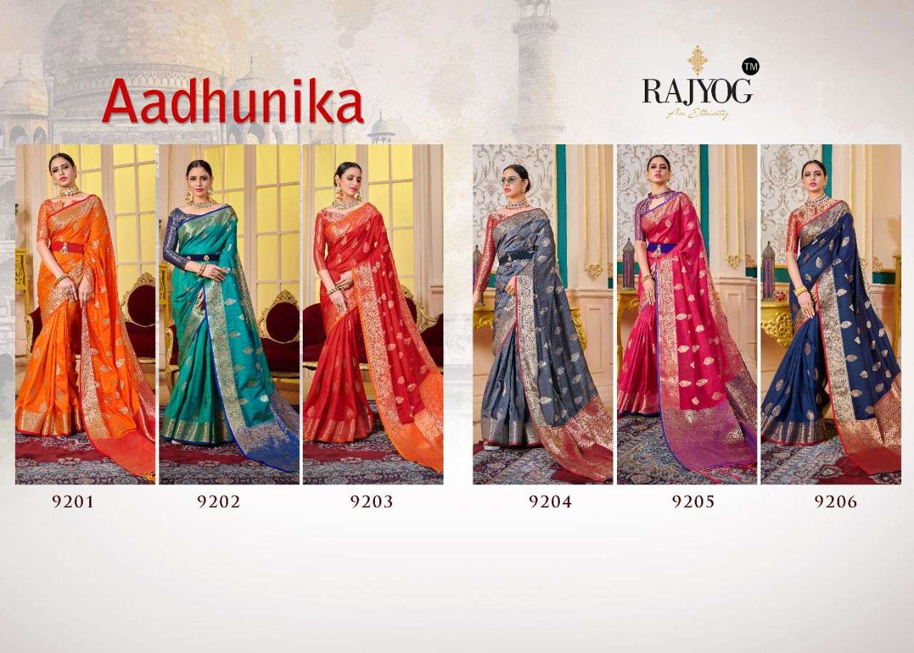 AADHUNIKA BY RAJYOG 9201 TO 9206 SERIES INDIAN TRADITIONAL WEAR COLLECTION BEAUTIFUL STYLISH FANCY COLORFUL PARTY WEAR & OCCASIONAL WEAR SOFT SILK SAREES AT WHOLESALE PRICE